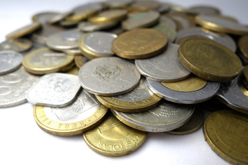 Old and new coins of different countries closeup on white background