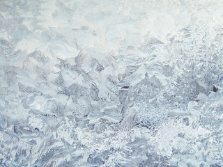Frosty patterns on the glass. Beautiful natural winter background.