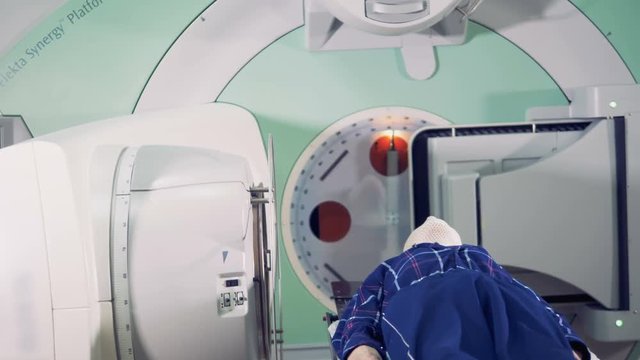 Lying person is being irradiated by a linear accelerator