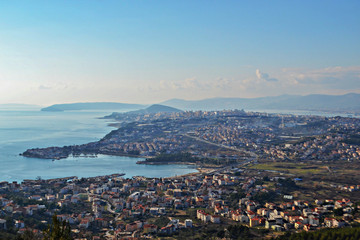 Aerial view from the top at the city, sky and sea as background 