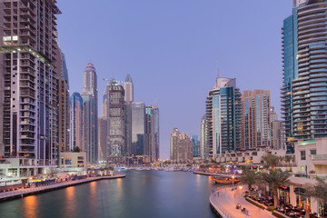 Fototapeta na wymiar Modern skyline and sidewalk around Dubai Marina waterfront