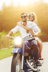 Fototapeta na wymiar beautiful couple on retro motorbike