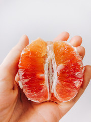 Half red orange lies on the arm vertically