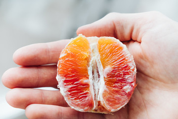 Half of the red orange lies on the arm