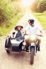 beautiful couple on retro motorbike