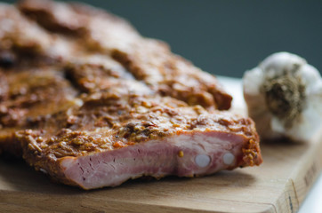 Spareribs with spices and fresh garlic on wooden background