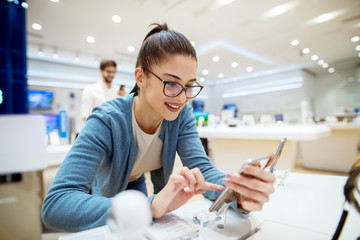 Young woman using smartphone in office