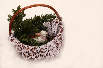 Polish easter traditions - beautiful wicker basket, with white hand made cloth, and old white lamb, with food to be blessed in church