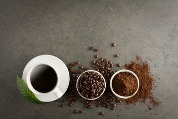 Coffee cup and beans on old kitchen table. Top view with copyspace