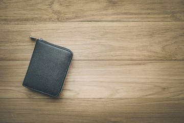 Black wallet on wood