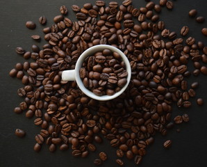 Roasted Coffee Beans, White Cup, on a Black Background