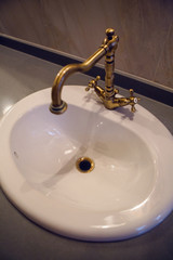 white sink with copper mixer tap