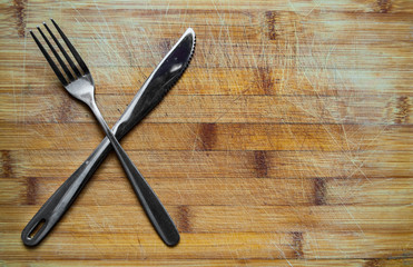 Silver Knife and fork on wooden table with copy space. top view