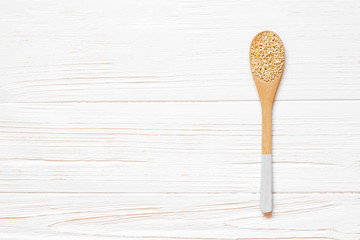 Wooden spoon with quinoa seeds on white wooden table. Concept of a healthy diet. Super food.
