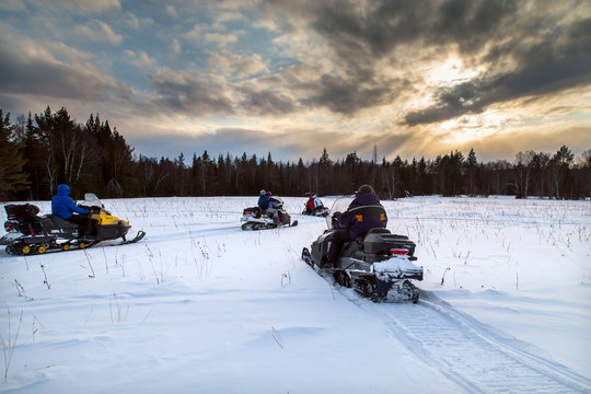 Athletes on a snowmobile