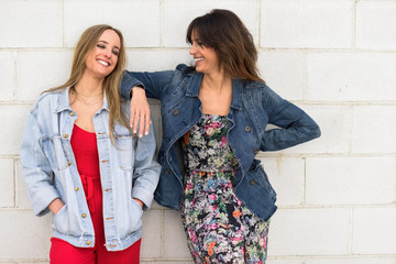 Two young women smiling in urban background