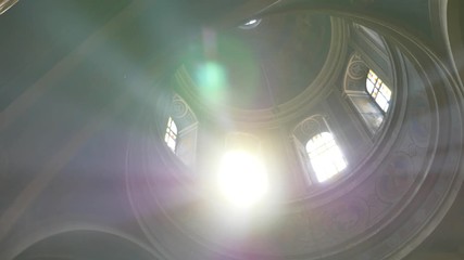 Sun light passes through the stained glass windows of the church - Powered by Adobe