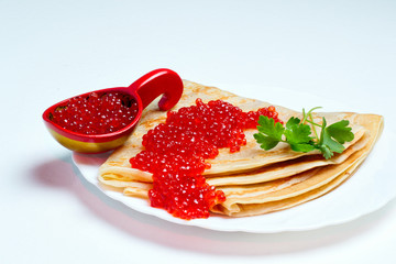 pancakes with caviar on a white plate