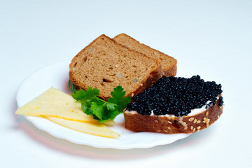 caviar sandwich on a white plate with cheese