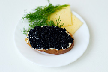 caviar sandwich on a white plate with cheese