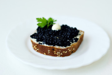 caviar sandwich on a white plate