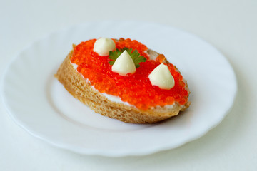 caviar sandwich on a white plate