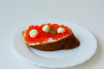 caviar sandwich on a white plate