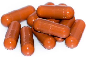 Lot of red pills on white background