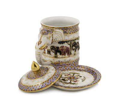 Handmade ceramic mug elephant head decorated with white background.