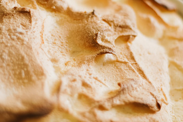 Close up of traditional, golden baked Austrian Soufflé dumpling dish, called Salzburger Nockerl, made of eggs, flour, sugar and vanilla, served warm and dusted with powdered sugar