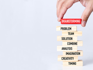 Businessman Building BRAINSTORMING Concept with Wooden Blocks