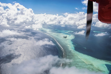 Seaplane aerial view of beautiful tropical Maldive island and sea