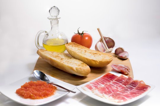 Typical Spanish Breakfast Consisting Of Iberian Acorn-fed Ham With Grated Tomato, Artisan Toast, Natural Garlic And Extra Virgin Olive Oil