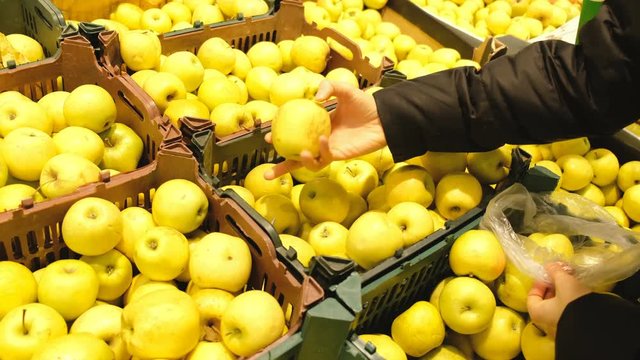 Woman buys apples on a market