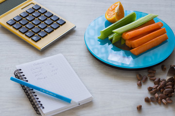Vegetables and nuts on the scales. Calorie counting