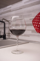 glass of red wine in the kitchen