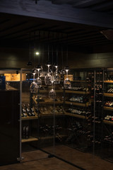 Wine cellar in an expensive luxury restaurant and a fashionable chandelier in the form of glasses.