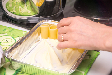 Italian woman cooks and season Italian pasta