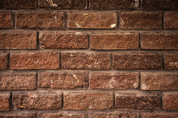 Textured background of antique decorative brick with easy vignetting. Medieval background for a brick wall