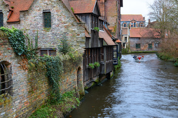 Fototapeta na wymiar Canal in historic centre of Bruges or Brugge, Belgium with buildings in medieval style