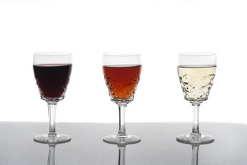 Three glasses of wine, rose wine, red wine, white wine, white background
