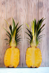Pineapple halves over wooden background