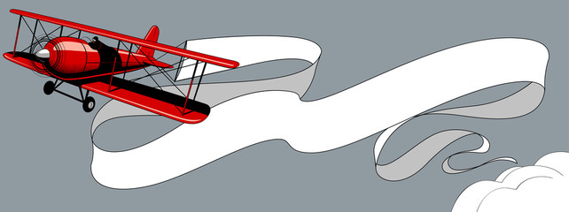 Retro red airplane with a big white ribbon banner in the sky © Raman Maisei