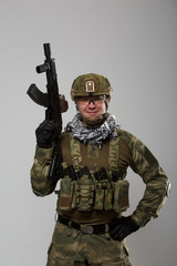 Photo of soldier in safety glasses with gun in his hand