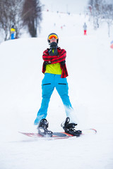 Fototapeta na wymiar Photo of standing athlete with snowboard in winter park during day.