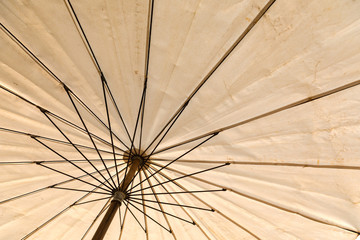 Old white beach umbrella
