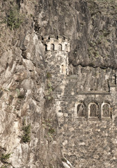 Disguised as a castle in the mountain. Stone medieval house. The attraction of Prague