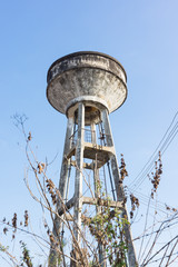 old concrete tower as a water tank against blue sky