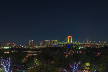 View of Tokyo Bay, Rainbow bridge and Tokyo Tower landmark, Night scene, Odaiba, Japan