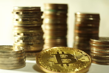 Bit coin business conceop, metal bitcoin token with  other different coin stacks